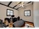 Bedroom featuring hardwood floors, white walls, black beams and natural lighting from two windows at 3007 Pasadena Dr, Decatur, GA 30032