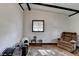 Bedroom featuring hardwood floors, white walls, black beams, vintage area rug and a lounge chair at 3007 Pasadena Dr, Decatur, GA 30032