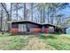Charming single-Gathering house with mature trees, a brick foundation and lush green lawn at 3007 Pasadena Dr, Decatur, GA 30032