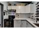 Well lit kitchen with white cabinets, stone tile backsplash, modern appliances and plenty of counter space at 3007 Pasadena Dr, Decatur, GA 30032