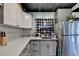 Bright, galley-style kitchen with stainless steel refrigerator, stone tile backsplash and stone countertops at 3007 Pasadena Dr, Decatur, GA 30032