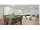 A finished basement with pool table and sofa, perfect for entertaining and relaxing at 3061 Stone Bridge Sw Trl, Conyers, GA 30094