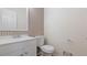 A traditional half bath featuring white fixtures, neutral paint, and stylish wallpaper at 3061 Stone Bridge Sw Trl, Conyers, GA 30094
