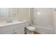 Traditional bathroom featuring a white vanity, toilet and bath with shower at 3061 Stone Bridge Sw Trl, Conyers, GA 30094