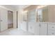 This updated bathroom features double sinks with modern fixtures and stylish wallpaper at 3061 Stone Bridge Sw Trl, Conyers, GA 30094