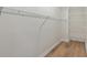 Walk-in closet with wire shelving and wood-look flooring at 3061 Stone Bridge Sw Trl, Conyers, GA 30094