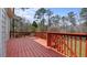 An expansive wooden deck is stained a beautiful redwood color and overlooks the backyard at 3061 Stone Bridge Sw Trl, Conyers, GA 30094