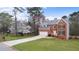 Charming brick home with lush lawn, long driveway, mature trees, and attached garage at 3061 Stone Bridge Sw Trl, Conyers, GA 30094