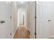 Hallway with multiple doors and wood floors at 3061 Stone Bridge Sw Trl, Conyers, GA 30094