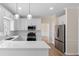 Modern kitchen featuring quartz countertops, stainless appliances, and bright white cabinets at 3061 Stone Bridge Sw Trl, Conyers, GA 30094