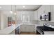 Bright kitchen featuring quartz countertops, stainless appliances and a view to the backyard at 3061 Stone Bridge Sw Trl, Conyers, GA 30094