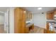 A spacious kitchen featuring lots of wood cabinets, countertops, and a desk at 3061 Stone Bridge Sw Trl, Conyers, GA 30094
