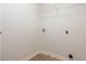 A simple laundry area features hookups and a wire shelf for storage at 3061 Stone Bridge Sw Trl, Conyers, GA 30094