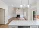 Open-concept living room with fireplace, built-ins, hardwood floors, and slider to deck at 3061 Stone Bridge Sw Trl, Conyers, GA 30094