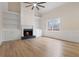 Open living room with fireplace, built-in shelving, and wood-look floors at 3061 Stone Bridge Sw Trl, Conyers, GA 30094