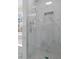 Marble tiled shower with glass door and built in shelf at 3061 Stone Bridge Sw Trl, Conyers, GA 30094
