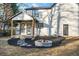 The backyard includes a covered porch, stone fire pit, and manicured landscaping at 6382 Revena Dr, Morrow, GA 30260