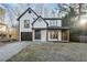 Charming two-story home with a front porch, garage, and manicured lawn at 6382 Revena Dr, Morrow, GA 30260