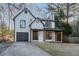 Beautiful two-story home with a front porch, garage, and well-maintained landscaping at 6382 Revena Dr, Morrow, GA 30260
