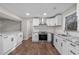 Well-equipped kitchen featuring granite countertops, stainless steel appliances, and sleek white cabinets at 6382 Revena Dr, Morrow, GA 30260