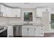 Stylish kitchen with stainless steel appliances, granite countertops, and white cabinetry at 6382 Revena Dr, Morrow, GA 30260
