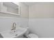 Powder room features a pedestal sink, vintage-style mirror, and beadboard accents at 6382 Revena Dr, Morrow, GA 30260