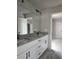 Bathroom vanity featuring double sinks, granite countertop, and modern fixtures at 6841 Phillips Mill Rd, Douglasville, GA 30135