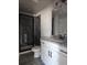 Bathroom features black fixtures, a granite countertop, and a shower with glass doors at 6841 Phillips Mill Rd, Douglasville, GA 30135