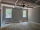 A sunny bedroom features a ceiling fan, trim detail, and large windows at 6841 Phillips Mill Rd, Douglasville, GA 30135