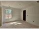 Bedroom in the process of being remodeled features a large window with wooded view at 6841 Phillips Mill Rd, Douglasville, GA 30135