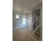 Welcoming foyer with staircase featuring iron balusters, complemented by modern lighting and classic trim at 6841 Phillips Mill Rd, Douglasville, GA 30135