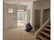 Unfinished entryway with a view of the outdoors and stairs ready for finishing touches at 6841 Phillips Mill Rd, Douglasville, GA 30135
