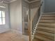 Welcoming foyer with staircase, showcasing natural light, neutral paint, and stylish finishes at 6841 Phillips Mill Rd, Douglasville, GA 30135