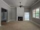 Spacious living area featuring fireplace with shiplap, modern ceiling fan, and windows at 6841 Phillips Mill Rd, Douglasville, GA 30135