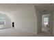 Open concept living room under construction featuring a vaulted ceiling and natural light at 6841 Phillips Mill Rd, Douglasville, GA 30135