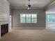 Inviting living room with fireplace featuring white shiplap and a large window providing ample natural light at 6841 Phillips Mill Rd, Douglasville, GA 30135