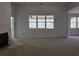 Unfinished living room with large windows providing ample natural light at 6841 Phillips Mill Rd, Douglasville, GA 30135