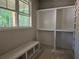 Custom walk-in closet features a built-in bench, shelving, and a large window with a scenic view at 6841 Phillips Mill Rd, Douglasville, GA 30135