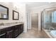 Modern bathroom featuring double sink vanity, granite countertops, soaking tub, and tiled walk-in shower at 830 Nottingham Se Dr, Smyrna, GA 30082