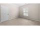 This carpeted bedroom has a large window and a door at 830 Nottingham Se Dr, Smyrna, GA 30082