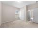 Carpeted bedroom with double door closet and natural light from a large window at 830 Nottingham Se Dr, Smyrna, GA 30082