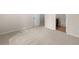 Carpeted bedroom with open doorway to the en suite bathroom at 830 Nottingham Se Dr, Smyrna, GA 30082