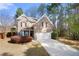 Charming two-story brick home features a well-manicured lawn and an attached two-car garage at 830 Nottingham Se Dr, Smyrna, GA 30082