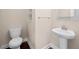 Cozy half bathroom with a pedestal sink and decorative mirror, perfect for guests at 830 Nottingham Se Dr, Smyrna, GA 30082