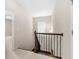 Hallway with carpeted floor and stairway with dark wood banister, showcasing the home's interior design and architectural details at 830 Nottingham Se Dr, Smyrna, GA 30082