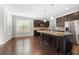 Kitchen with dark cabinetry, stainless steel appliances, granite countertops, and a spacious center island at 830 Nottingham Se Dr, Smyrna, GA 30082