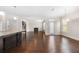Bright kitchen featuring granite countertops, dark cabinets, stainless appliances, and dark hardwood floors leading to a living room at 830 Nottingham Se Dr, Smyrna, GA 30082