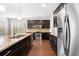 Modern kitchen with dark wood cabinets, stainless steel appliances, and granite countertops, offering a sleek design at 830 Nottingham Se Dr, Smyrna, GA 30082
