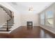 Inviting living room features a cozy fireplace, hardwood floors, and staircase at 830 Nottingham Se Dr, Smyrna, GA 30082