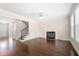 Inviting living room features a cozy fireplace, hardwood floors, and staircase at 830 Nottingham Se Dr, Smyrna, GA 30082